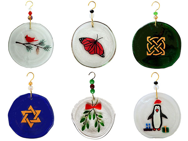 6 ornaments made from the bottom of upcycled wine bottles, with various painted designs